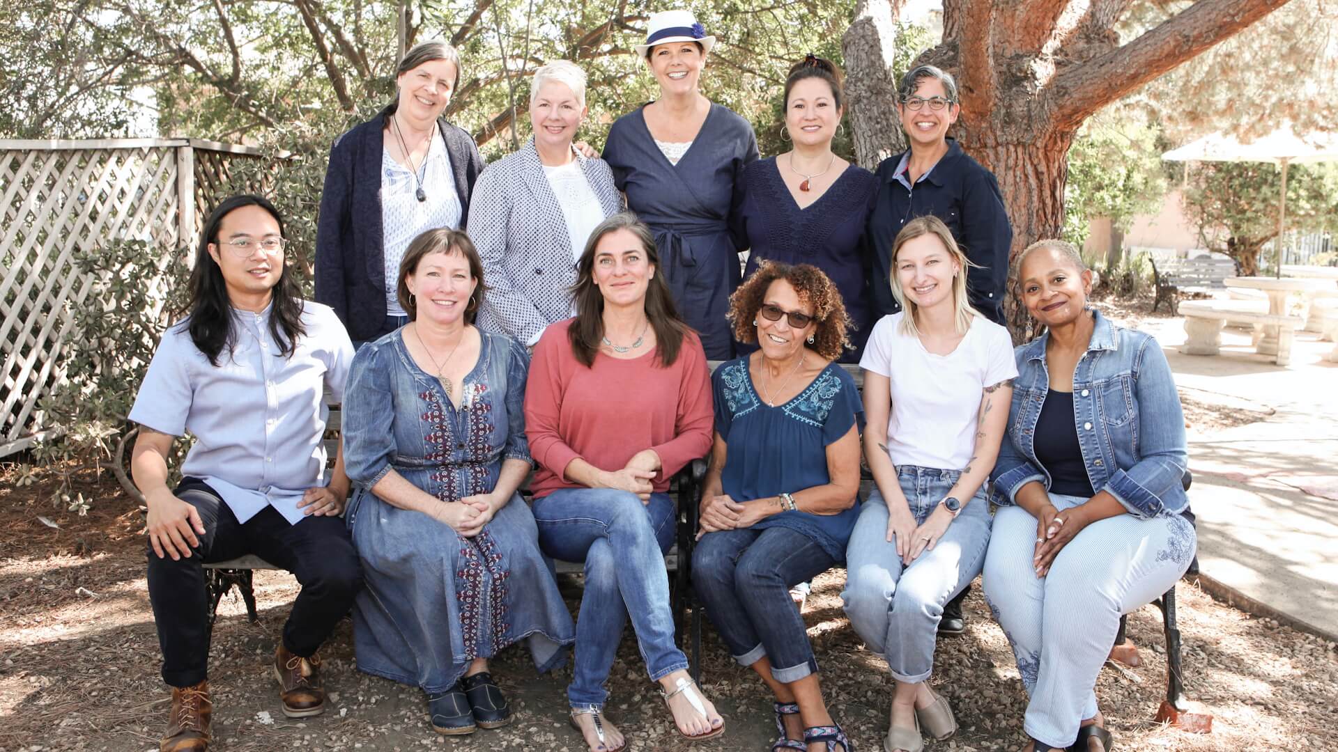Faculty members sit outside for a photograph.