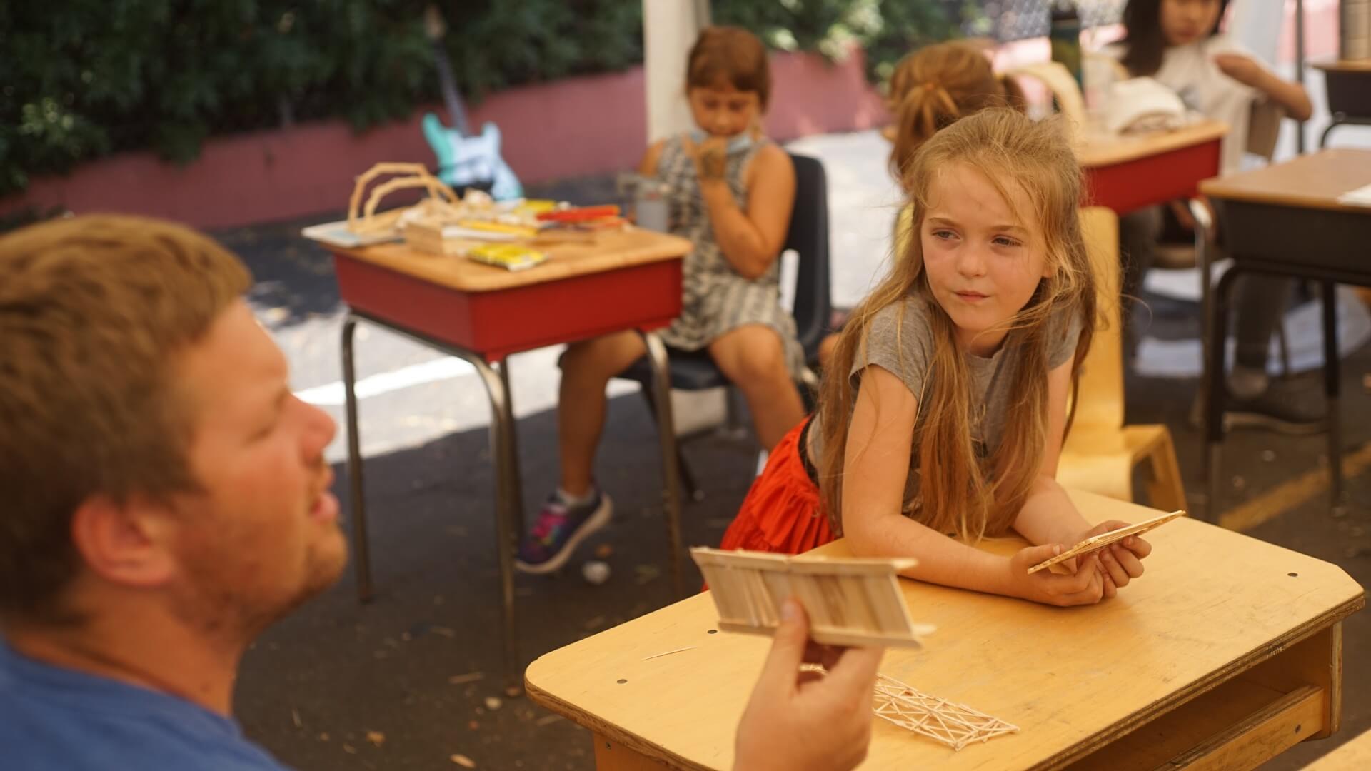 Lower School female student listens intently.