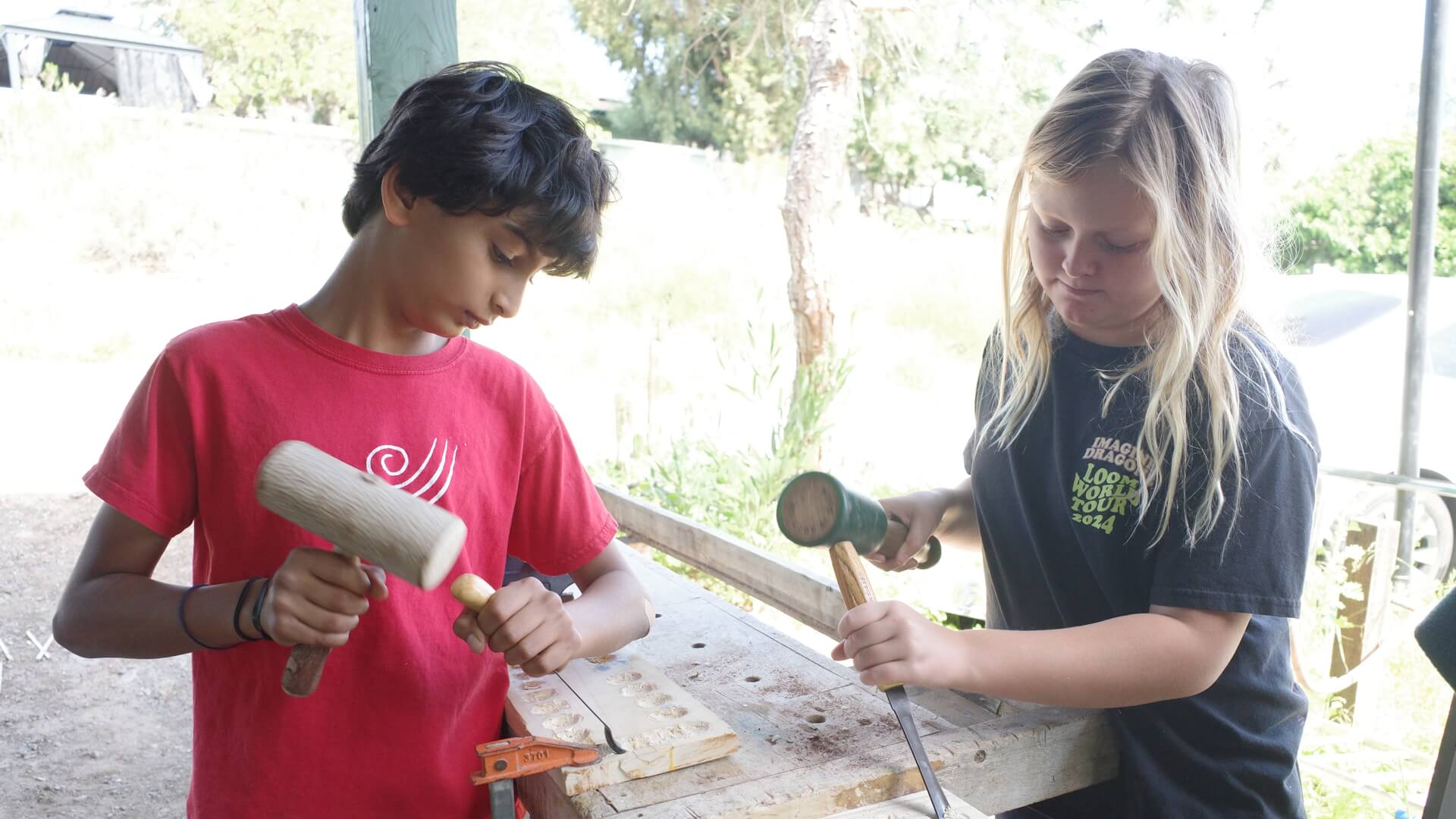 Lower School students carve wood.