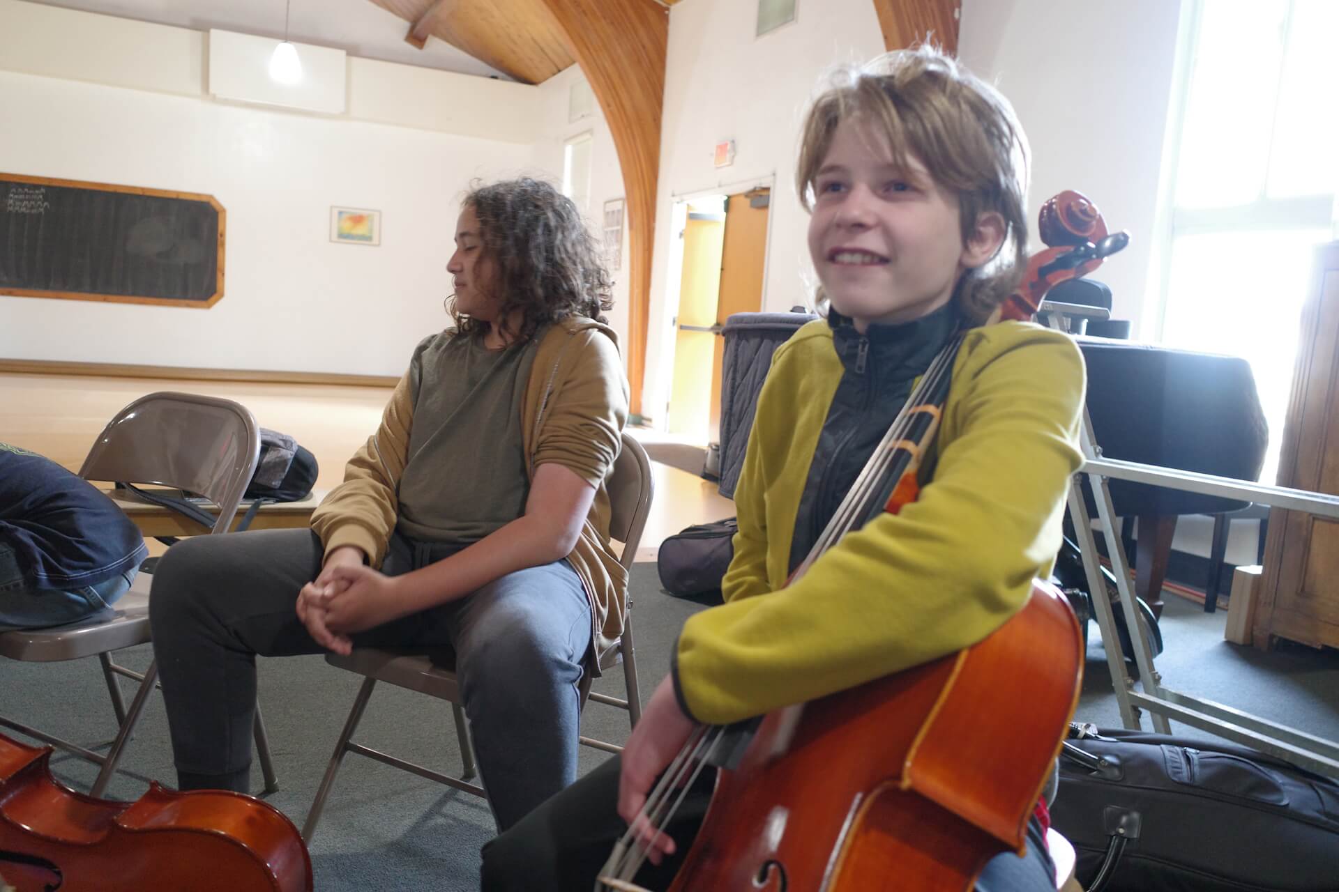Middle School male students in music class with bass viols.