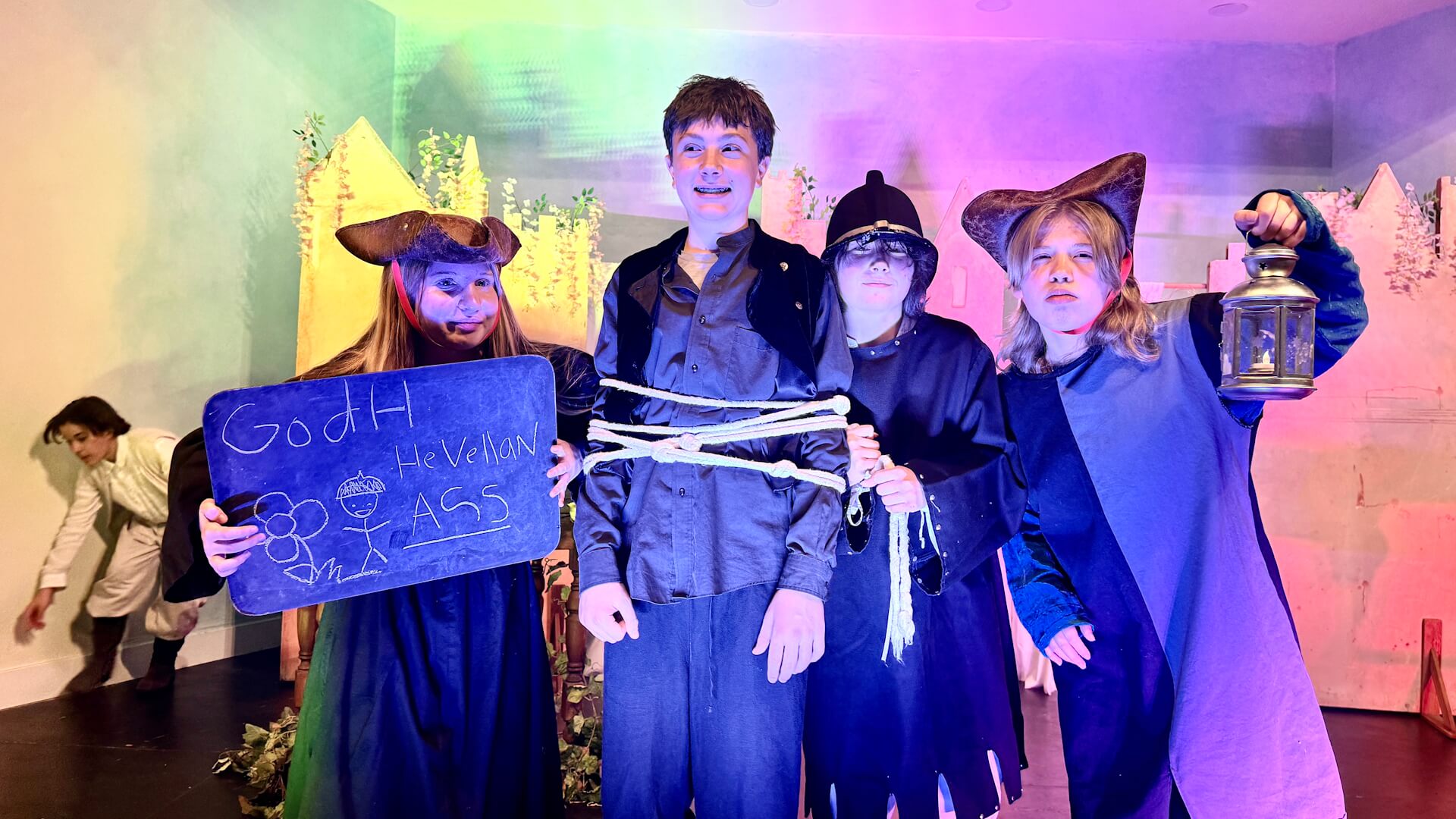 Middle School students perform a play in the theater.
