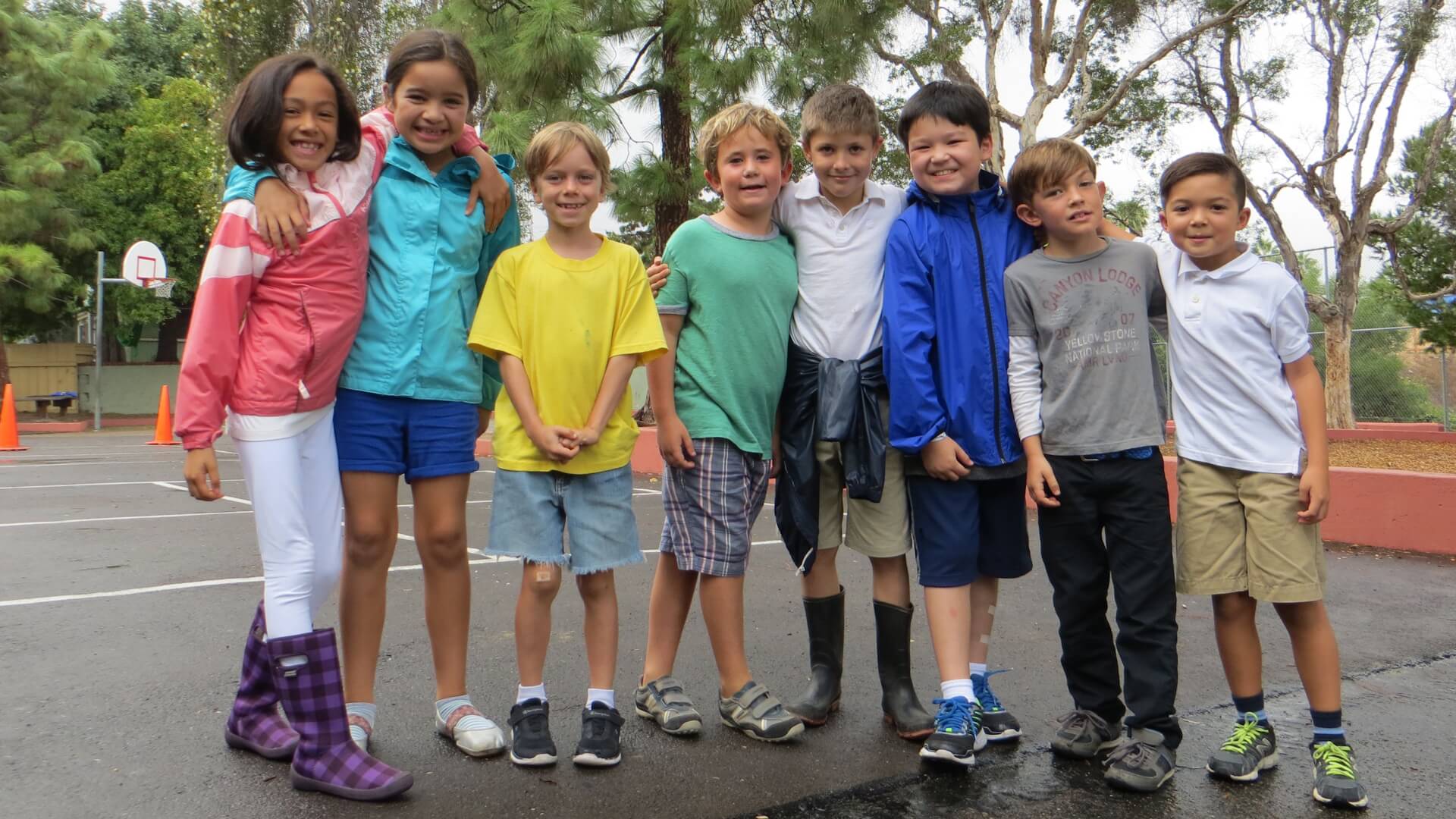 Lower School students outside on basketball courts.