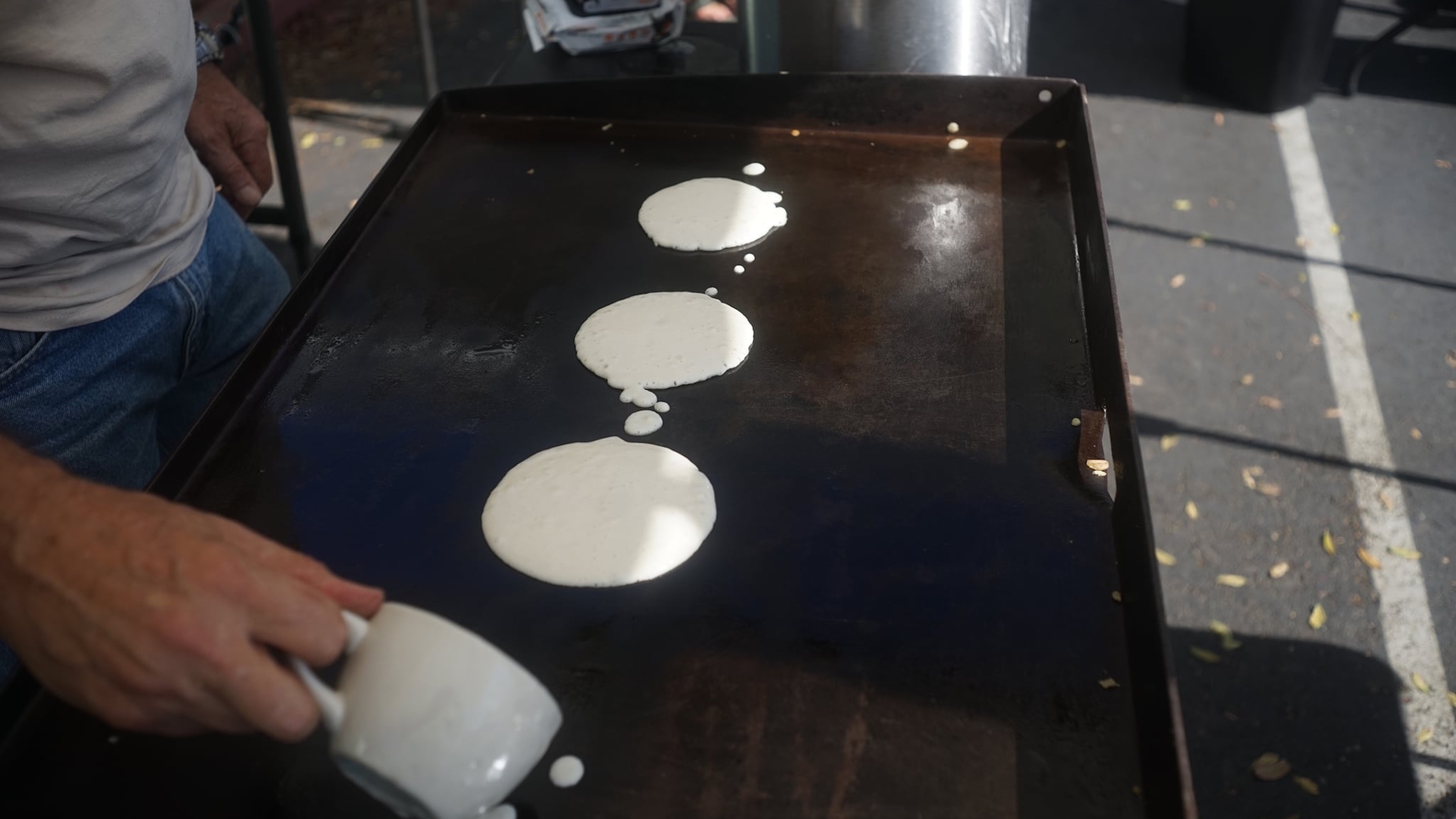 Frying pancakes on a griddle.