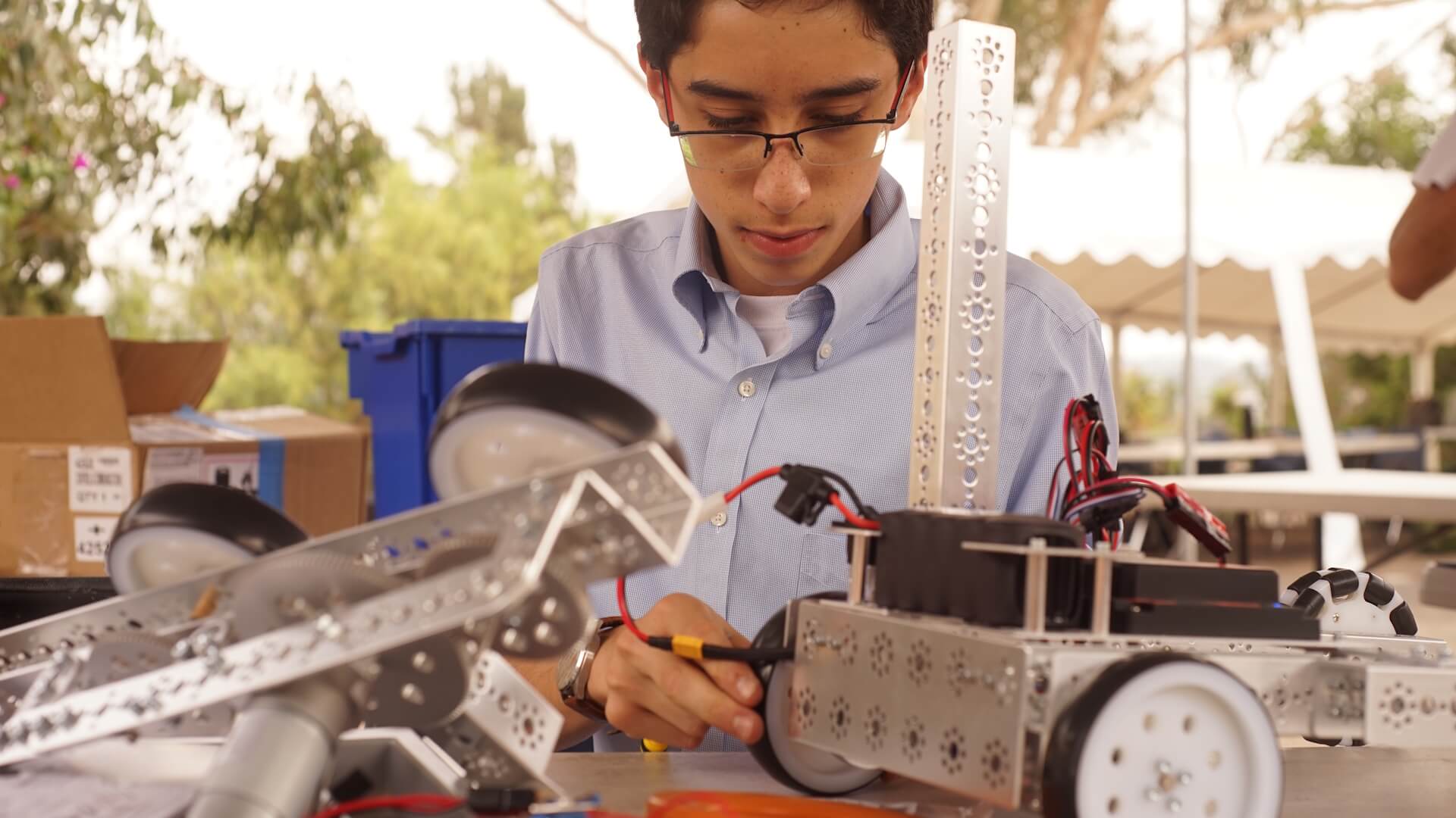 High School male student works with robotics