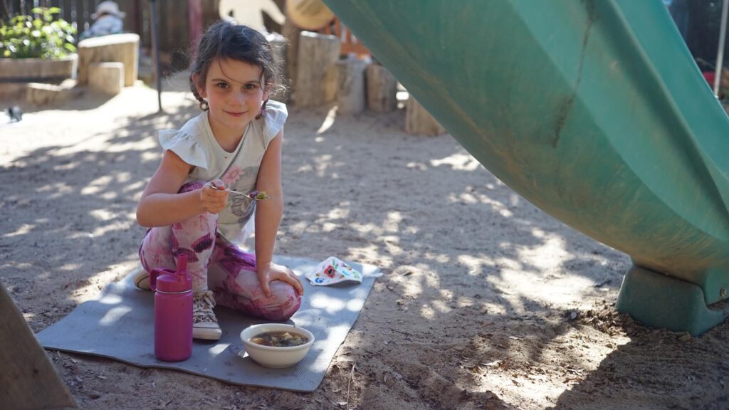 Lower School female student enjoying soup on Soup Day