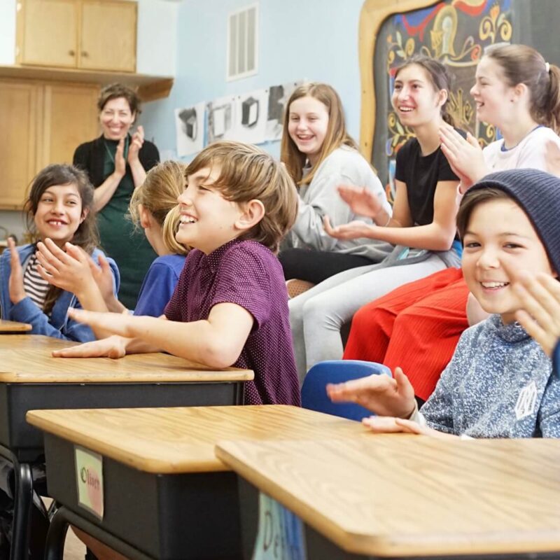 Lower School students clapping in class