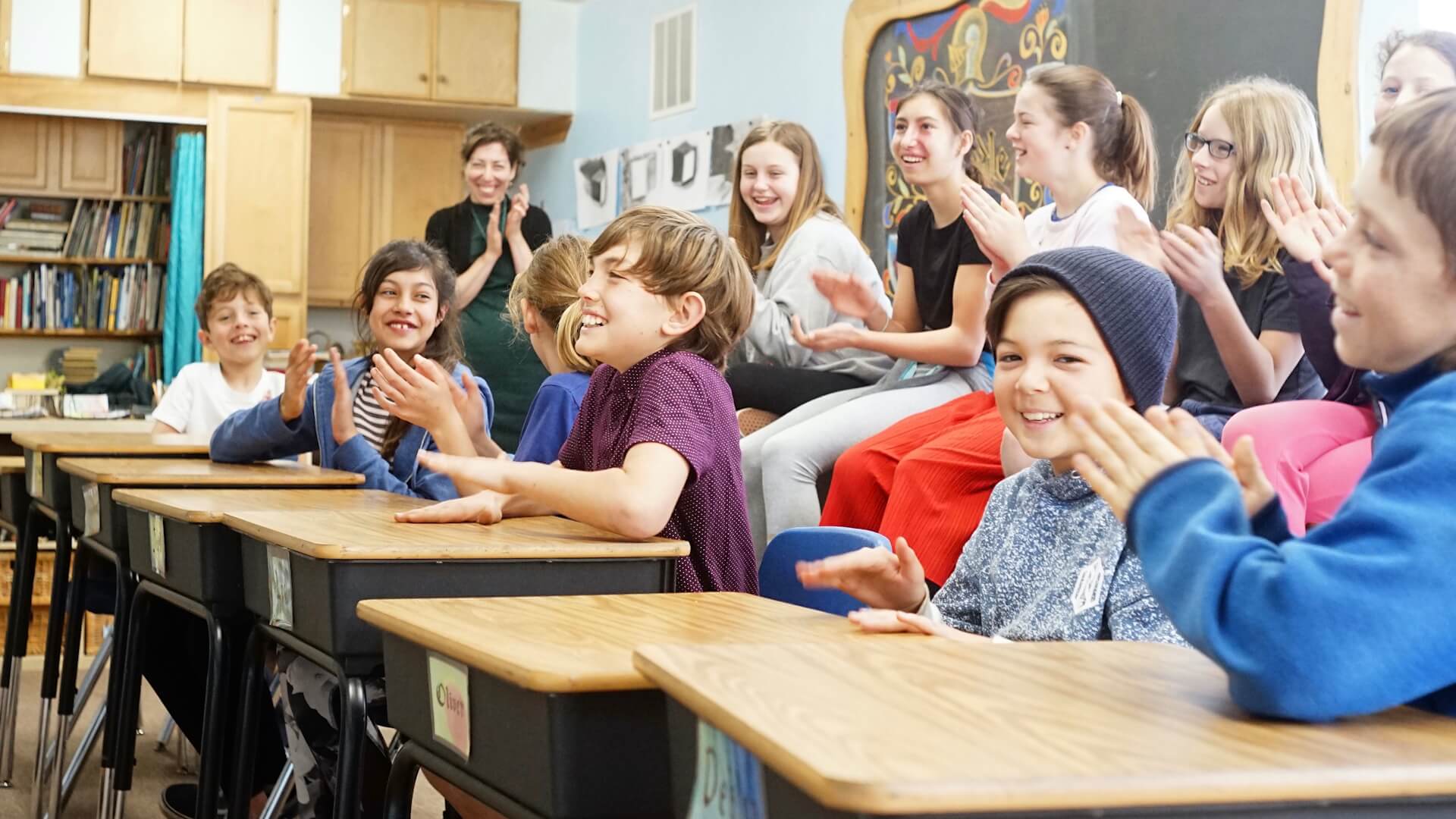 Lower School students clapping in class