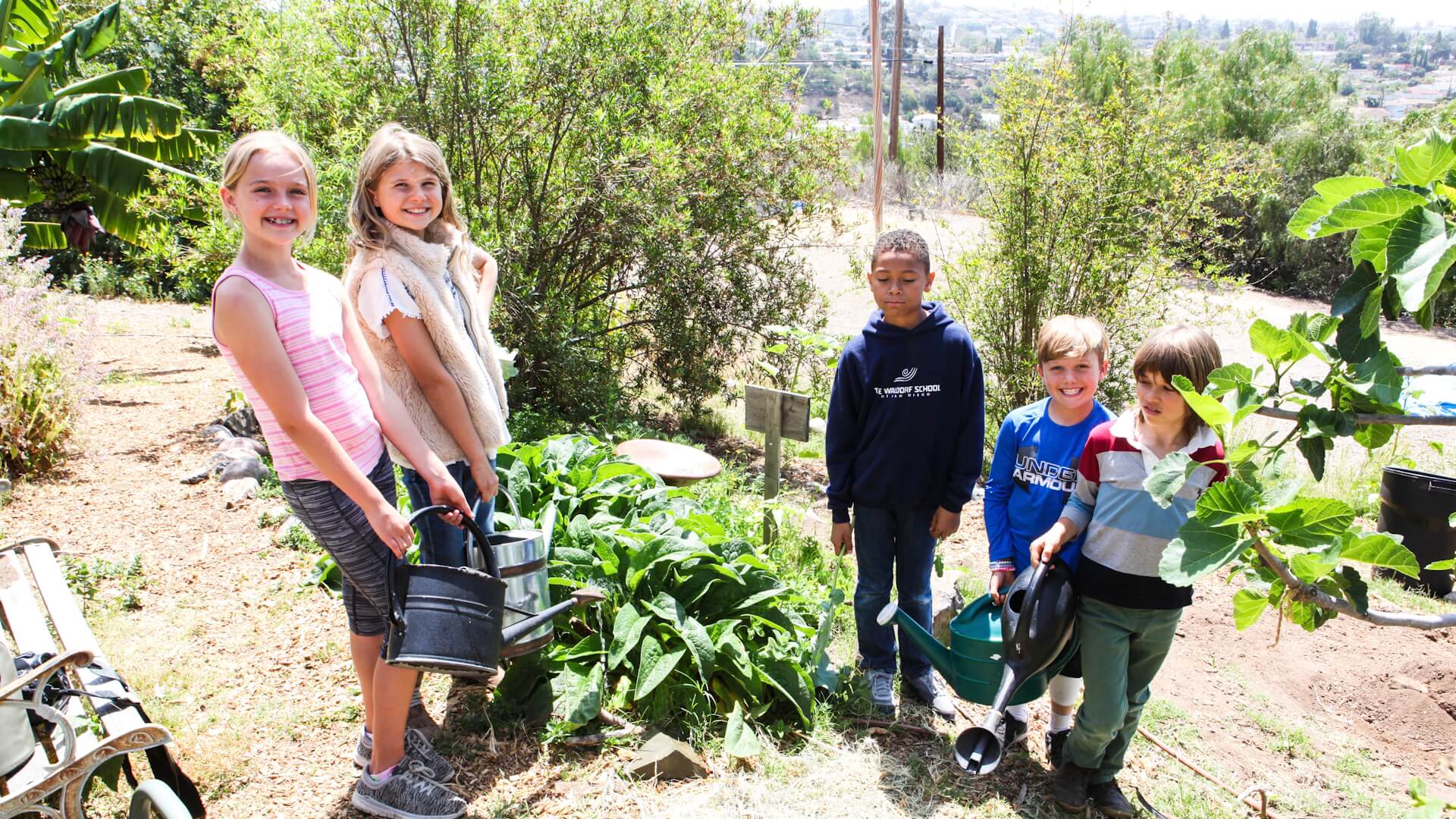 Lower School students gardening