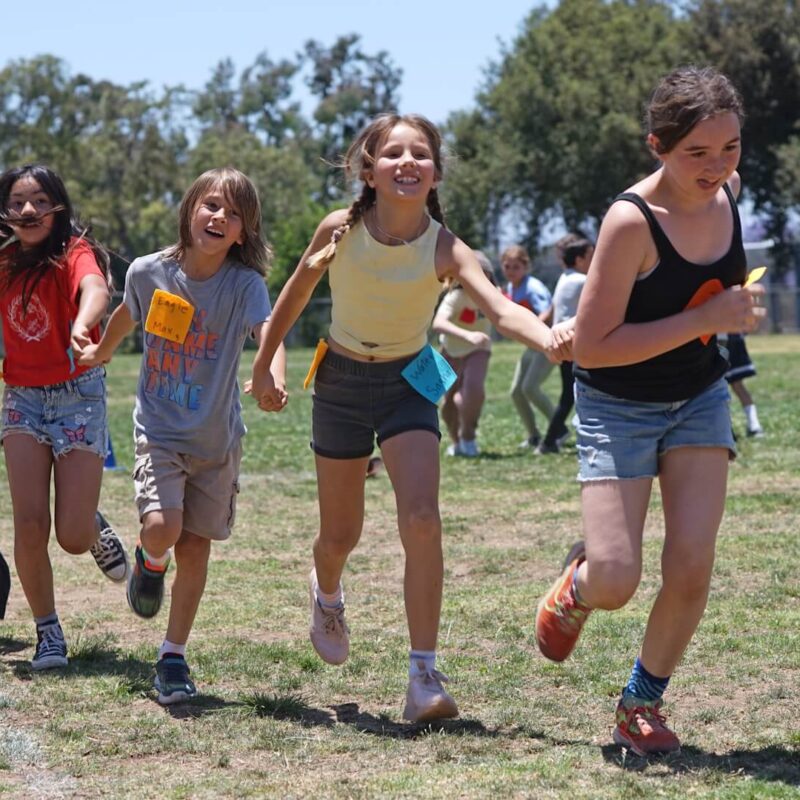Lower School students running in a field