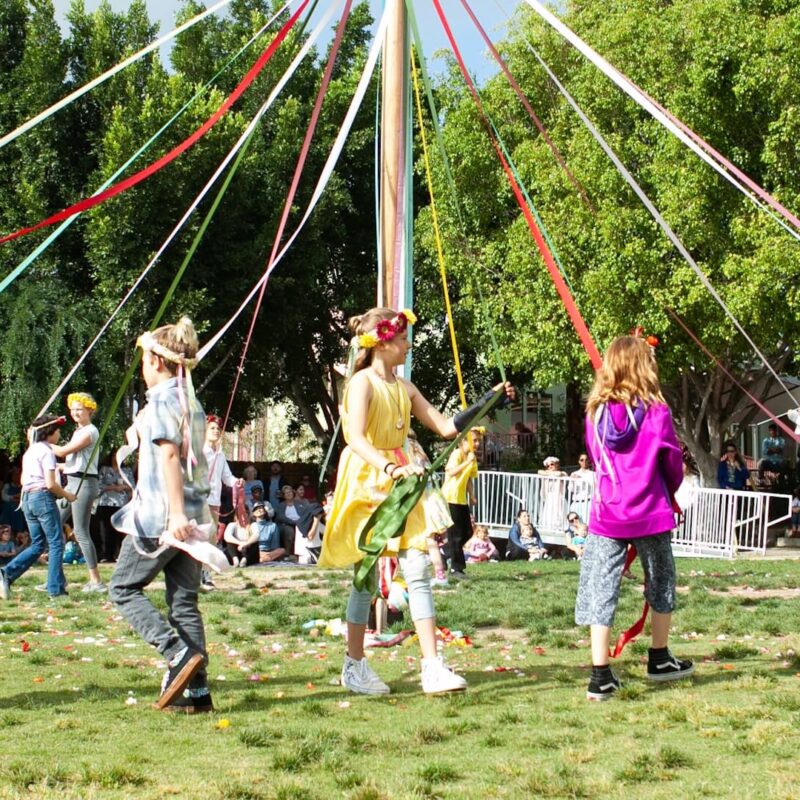 Students decorate the May pole on May Day